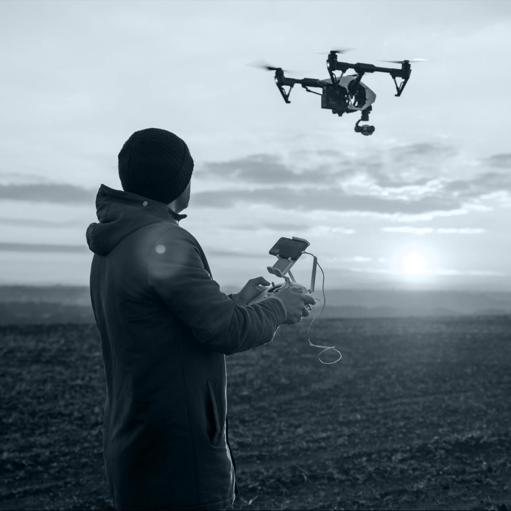 Drone pilot operating an aerial photography camera drone